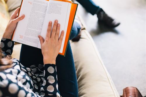 Photo of student with book open